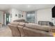 Inviting living room with comfortable seating, a sliding glass door, and neutral décor at 1010 Morvan Ln, Kissimmee, FL 34759