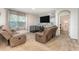 Cozy living room featuring reclining chairs, large windows, and a decorative wall accent at 1010 Morvan Ln, Kissimmee, FL 34759