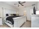 This main bedroom features an expansive bed, carpet floors and ceiling fan at 1010 Morvan Ln, Kissimmee, FL 34759