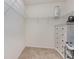Bright walk-in closet offers wire shelving and a crisp white dresser at 1010 Morvan Ln, Kissimmee, FL 34759