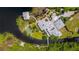 Aerial view of the property featuring a putting green, extensive landscaping, and waterfront access at 10300 Pocket Ln, Orlando, FL 32836