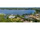 Expansive aerial view of waterfront homes on a lush green peninsula with a private canal with access to the adjacent large lake at 10300 Pocket Ln, Orlando, FL 32836