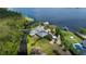 Aerial view of the home with lush landscaping, a private dock, and stunning waterfront views at 10300 Pocket Ln, Orlando, FL 32836