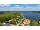 Aerial view showcasing the luxury community with waterfront homes, lush greenery, and tranquil lake views at 10300 Pocket Ln, Orlando, FL 32836