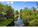 View along the canal, with lush vegetation, leading to the home and waterfront at 10300 Pocket Ln, Orlando, FL 32836