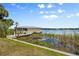 This beautiful property features a private dock and boat house on a serene lake with lush vegetation at 10300 Pocket Ln, Orlando, FL 32836