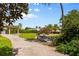 Paver driveway leading to a covered parking area with lush landscaping at 10300 Pocket Ln, Orlando, FL 32836