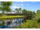 Beautiful waterfront home with lush landscaping, a canal, and a private bridge for peaceful lake access at 10300 Pocket Ln, Orlando, FL 32836