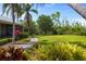 Manicured landscaping with a brick path leading through lush gardens and mature trees to the home at 10300 Pocket Ln, Orlando, FL 32836