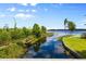 Scenic waterfront view featuring wooden walkways, lush greenery, and lake access for outdoor enjoyment at 10300 Pocket Ln, Orlando, FL 32836