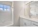 Bathroom featuring a vanity with storage, a large mirror and a tub with a shower at 10599 Satinwood Cir, Orlando, FL 32825