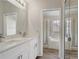 Bathroom featuring dual sinks and attached room with a bath tub and shower at 10599 Satinwood Cir, Orlando, FL 32825