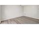 An empty room with wood-look flooring and fresh neutral paint at 10599 Satinwood Cir, Orlando, FL 32825