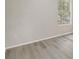 Neutral bedroom features wood-look flooring, fresh paint, and a window that lets in natural light at 10599 Satinwood Cir, Orlando, FL 32825