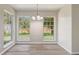 Bright dining room featuring wood-look flooring, a chandelier, and large windows that provide natural light at 10599 Satinwood Cir, Orlando, FL 32825