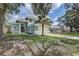 Charming two-story home featuring an attached two-car garage and mature trees in a manicured front yard at 10599 Satinwood Cir, Orlando, FL 32825