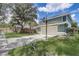 Exterior shot of the 2-car garage showing the driveway and partial yard and neighborhood view at 10599 Satinwood Cir, Orlando, FL 32825