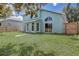Exterior home with a large yard and a privacy fence, as viewed from the back at 10599 Satinwood Cir, Orlando, FL 32825