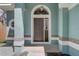 Inviting front entrance features a beautiful arched doorway and sidelight window for natural light at 10599 Satinwood Cir, Orlando, FL 32825