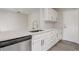 Bright kitchen features white cabinets, stainless steel appliances, and updated countertops at 10599 Satinwood Cir, Orlando, FL 32825