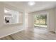 Inviting living area features wood-look floors, natural light, and an open layout to the kitchen at 10599 Satinwood Cir, Orlando, FL 32825