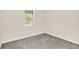 Empty bedroom with neutral walls, carpet floors, and a window offering natural light at 11139 Cyrilla Woods Dr, Orlando, FL 32832
