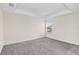 Bright bedroom with a tray ceiling, carpeted floor, and a window at 11139 Cyrilla Woods Dr, Orlando, FL 32832