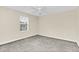 This bedroom features gray carpeting and a ceiling fan at 11139 Cyrilla Woods Dr, Orlando, FL 32832