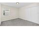 This cozy bedroom features gray carpeting and a window for natural light at 11139 Cyrilla Woods Dr, Orlando, FL 32832
