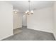 Bright dining room with neutral walls, grey carpet, and a modern chandelier, perfect for Gathering gatherings at 11139 Cyrilla Woods Dr, Orlando, FL 32832