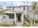 Charming two-story home with a well-manicured lawn and inviting front porch featuring brown shutters at 11139 Cyrilla Woods Dr, Orlando, FL 32832
