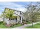 Inviting two-story home with a cozy front porch, complemented by lush landscaping and mature trees at 11139 Cyrilla Woods Dr, Orlando, FL 32832