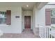 Inviting home entryway featuring brick pavers and a charming front door with dark brown shutters at 11139 Cyrilla Woods Dr, Orlando, FL 32832