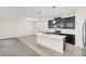 Modern kitchen with white quartz island, stainless steel appliances and black cabinets at 11139 Cyrilla Woods Dr, Orlando, FL 32832