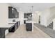 Open kitchen with stainless steel appliances, white countertops, a central island, and modern tile flooring at 11139 Cyrilla Woods Dr, Orlando, FL 32832