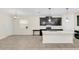 Spacious kitchen with white quartz island, stainless steel appliances, black cabinets, and ample natural light at 11139 Cyrilla Woods Dr, Orlando, FL 32832
