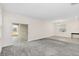 Open living area showcasing carpeted and tiled floors, a sliding glass door to the backyard, and ample natural light at 11139 Cyrilla Woods Dr, Orlando, FL 32832