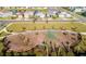Aerial view of playground featuring modern climbing structures, swings, and a soft surface, ideal for outdoor activities at 11139 Cyrilla Woods Dr, Orlando, FL 32832
