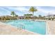 Resort-style pool area with sun loungers and ample space for relaxation under palm trees in a Gathering-friendly community at 11139 Cyrilla Woods Dr, Orlando, FL 32832