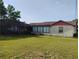 View of a grassy backyard featuring a screened-in enclosure at 1152 Ring St, Deltona, FL 32725