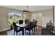 Dining room with hard wood floors, statement lighting and a view to the front yard at 1165 Indian Ridge E Trl, Kissimmee, FL 34747