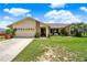 Charming single-story home with attached garage and well-maintained lawn at 1165 Indian Ridge E Trl, Kissimmee, FL 34747