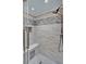 Modern tiled shower with a built-in seat and recessed shelf, offering a spa-like experience at 1165 Indian Ridge E Trl, Kissimmee, FL 34747
