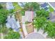 Aerial view of property with landscaped yard, driveway and mature trees at 126 Spanish Moss Ct, Orlando, FL 32828