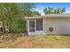 Back of the house features siding and a screened patio with mature trees and landscaping at 126 Spanish Moss Ct, Orlando, FL 32828