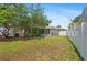 Wide shot of backyard with privacy fence, landscaping, patio and mature trees at 126 Spanish Moss Ct, Orlando, FL 32828