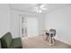 Comfortable bedroom features carpet, fan, window, work space and extra seating at 126 Spanish Moss Ct, Orlando, FL 32828