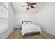 Comfortable bedroom with neutral colors, ceiling fan, and a large window at 126 Spanish Moss Ct, Orlando, FL 32828
