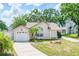 Charming single-story home featuring a well-manicured lawn, a one-car garage, and welcoming curb appeal at 126 Spanish Moss Ct, Orlando, FL 32828