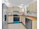 Well-lit kitchen boasts stainless steel appliances, ample cabinetry, and wood countertops at 126 Spanish Moss Ct, Orlando, FL 32828